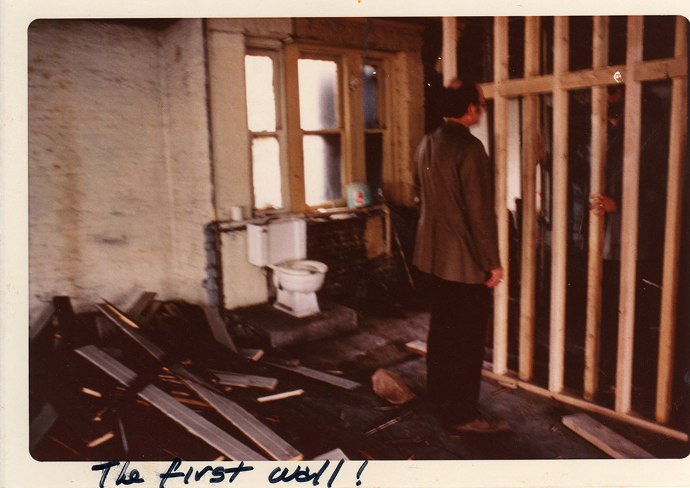 Mike, Jane's husband, inspecting the installation of the first wall in the loft. (image: Cass Collins)